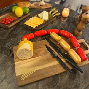 Homemade cocktail sausages on serving board